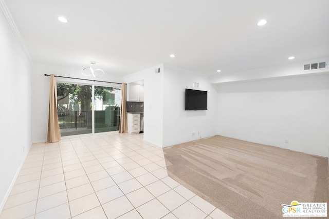 unfurnished living room featuring light carpet and ornamental molding