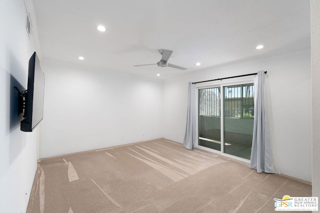 carpeted empty room with ceiling fan and ornamental molding