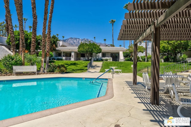 view of pool featuring a mountain view, a patio area, and a pergola