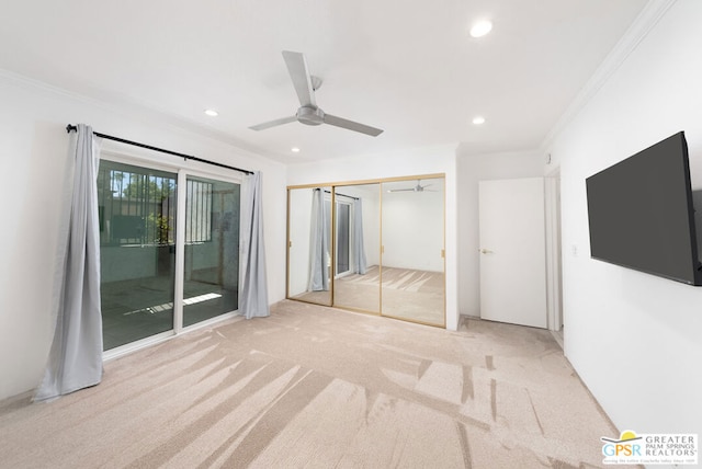 unfurnished bedroom featuring access to outside, a closet, light colored carpet, and ceiling fan