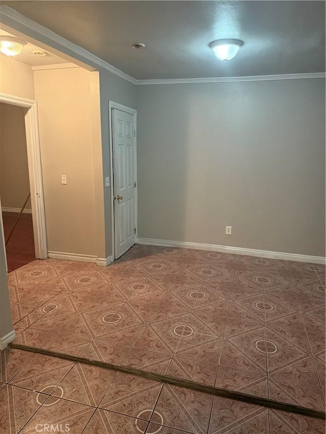 unfurnished room with ornamental molding and tile patterned floors