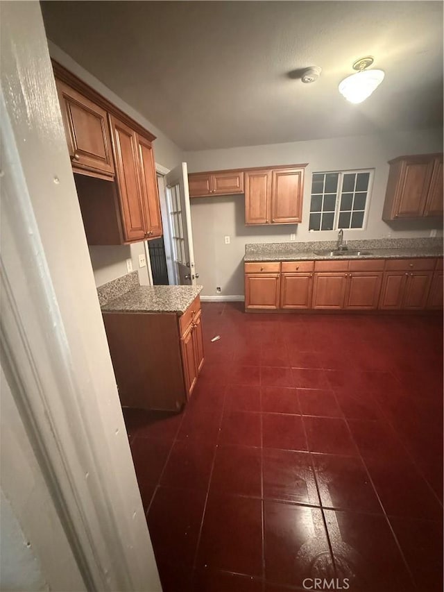 kitchen with sink and dark tile patterned flooring