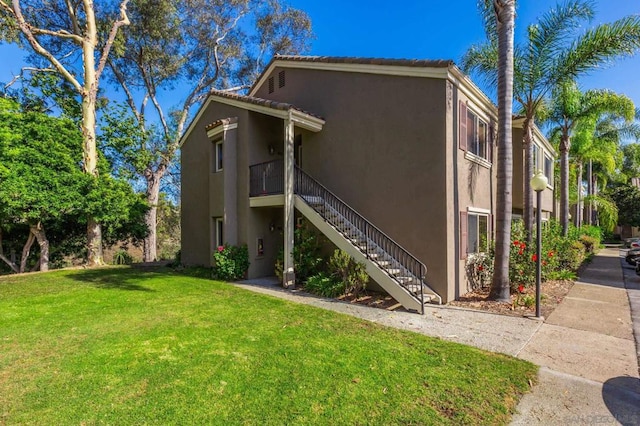 view of property exterior with a yard