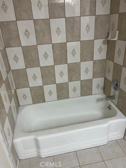 bathroom featuring a washtub and tile patterned flooring