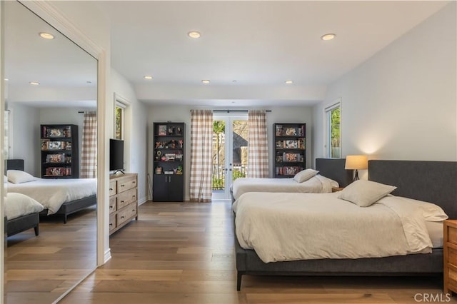 bedroom featuring hardwood / wood-style floors and access to outside