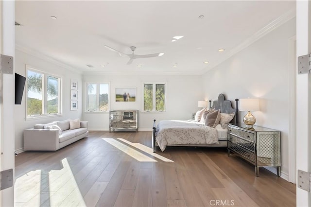 bedroom featuring hardwood / wood-style floors, ceiling fan, and ornamental molding