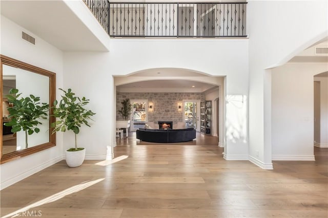 foyer entrance with hardwood / wood-style floors and a high ceiling