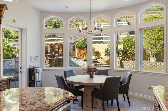 sunroom featuring a chandelier