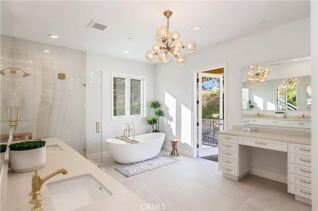 bathroom featuring a chandelier, vanity, tile patterned floors, and plus walk in shower