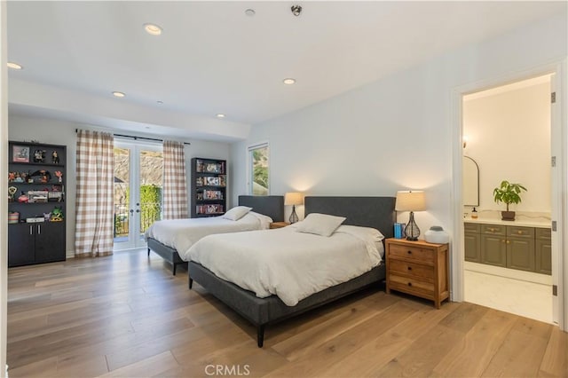 bedroom featuring ensuite bathroom, french doors, access to outside, and light hardwood / wood-style flooring