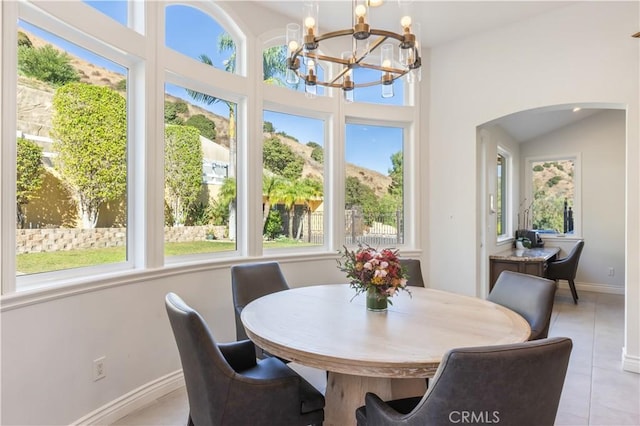 sunroom featuring plenty of natural light and a notable chandelier