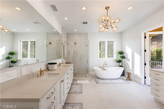 bathroom with a chandelier, tile patterned floors, vanity, and separate shower and tub