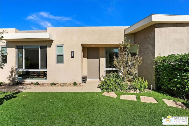 doorway to property with a yard