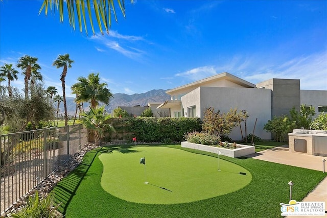 view of property's community with a mountain view and a patio