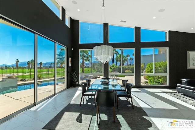 sunroom with a wealth of natural light and an inviting chandelier