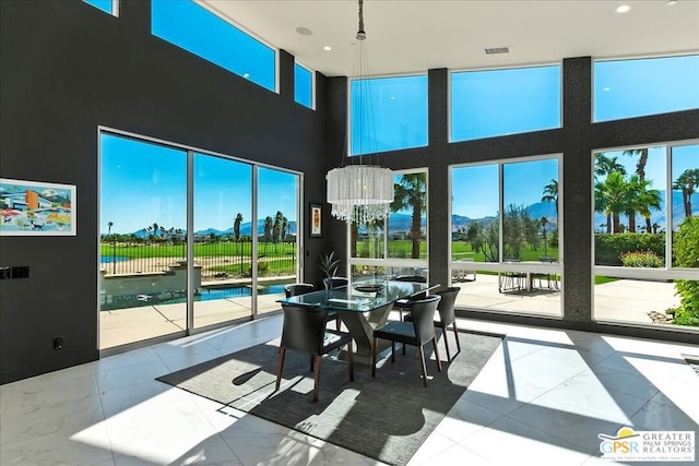 sunroom / solarium with a healthy amount of sunlight and a chandelier