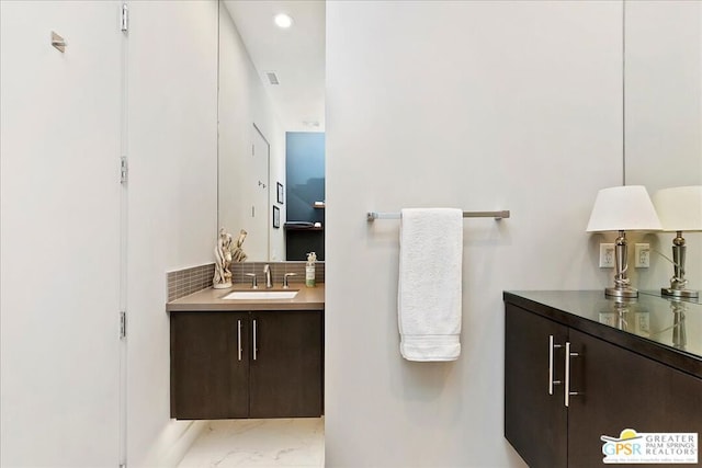 bathroom featuring backsplash and vanity