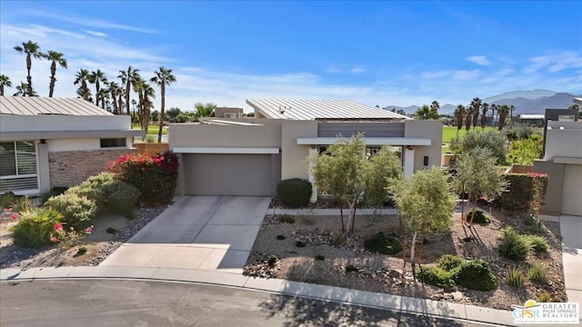 view of front of property featuring a mountain view and a garage