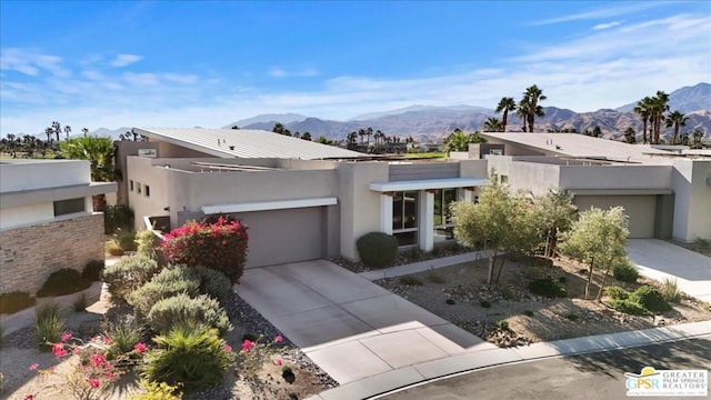 modern home with a mountain view and a garage