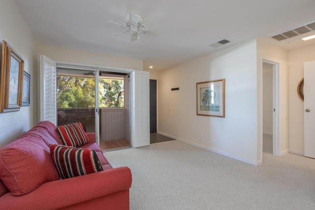 carpeted living room with ceiling fan