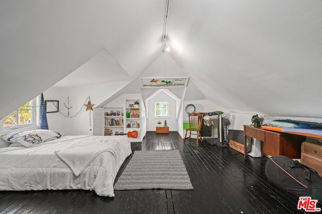 bedroom featuring dark hardwood / wood-style flooring and vaulted ceiling