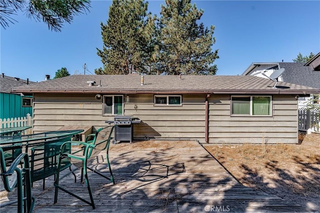 rear view of property featuring a deck