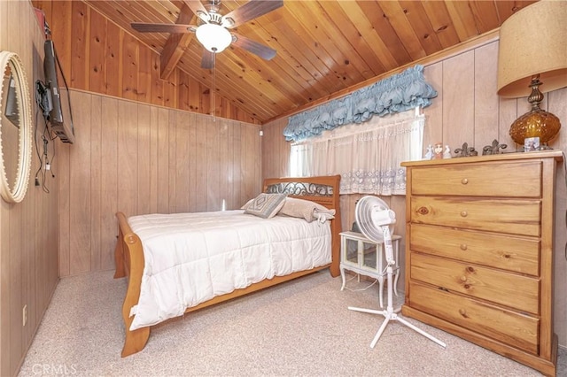 bedroom featuring lofted ceiling, wooden ceiling, wooden walls, ceiling fan, and light colored carpet