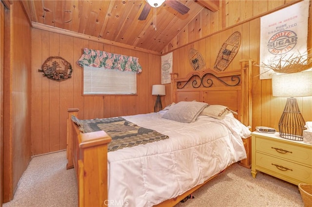 bedroom with vaulted ceiling with beams, wood walls, light colored carpet, and ceiling fan