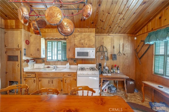 kitchen featuring white appliances, wooden ceiling, and sink