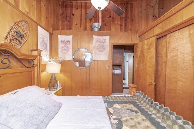 bedroom with wood walls, a towering ceiling, and a closet