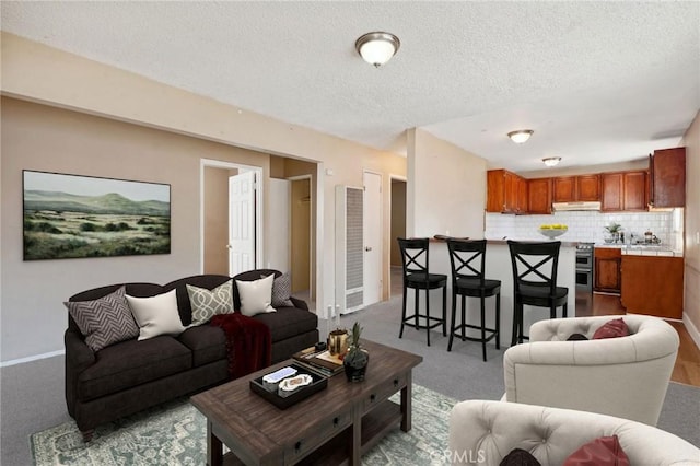 living room with light carpet and a textured ceiling