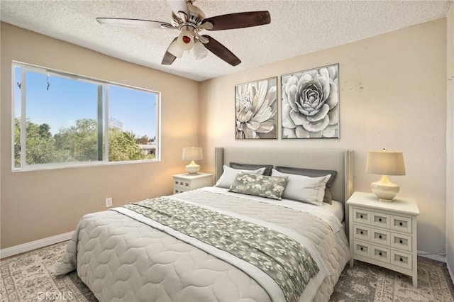 bedroom with ceiling fan and a textured ceiling