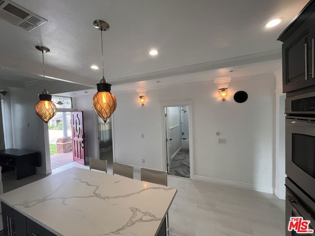 kitchen featuring light stone countertops, crown molding, and pendant lighting