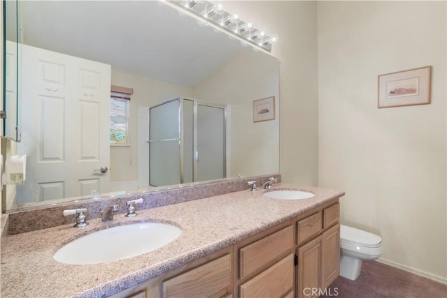 bathroom featuring vanity, toilet, and a shower with door