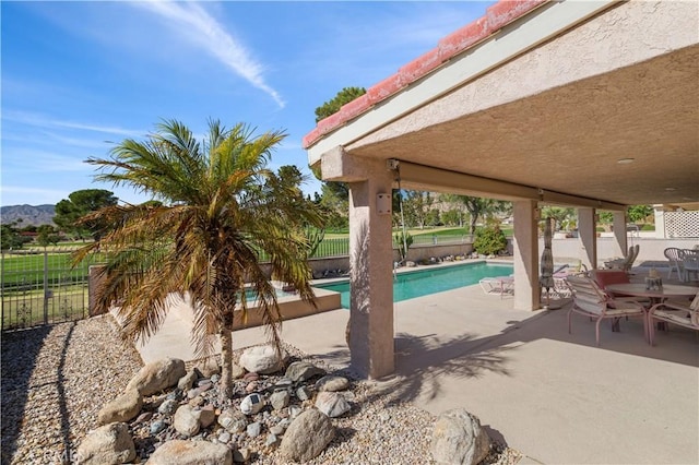 view of pool featuring a mountain view and a patio