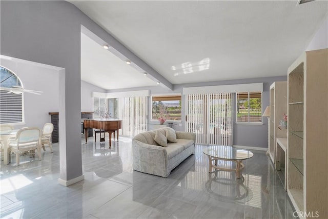 living room with plenty of natural light and beamed ceiling