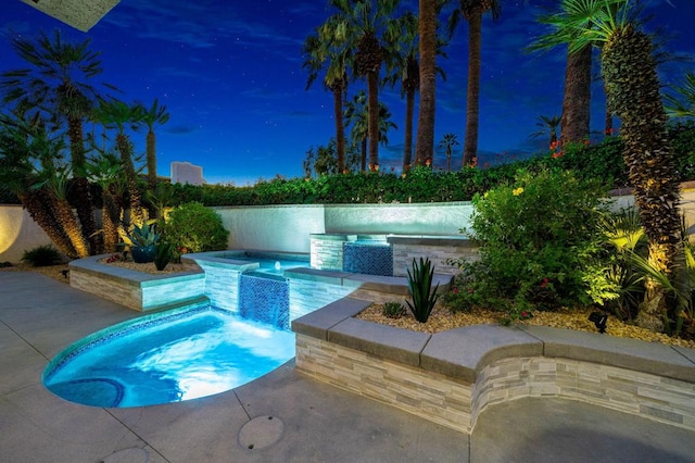 view of pool with an in ground hot tub