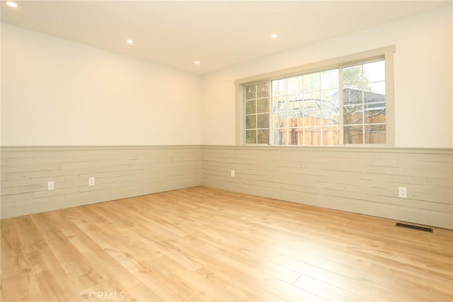 spare room with light hardwood / wood-style floors