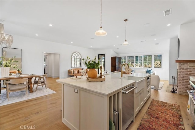 337 Holmwood Dr, Newport Beach, CA 92663 - kitchen with light wood-style floors, dishwasher, plenty of natural light, light stone countertops, and recessed lighting