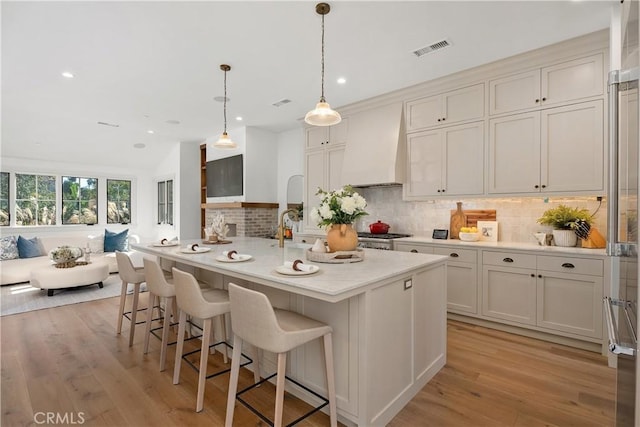337 Holmwood Dr, Newport Beach, CA 92663 - kitchen featuring premium range hood, recessed lighting, light countertops, backsplash, and light wood-style flooring