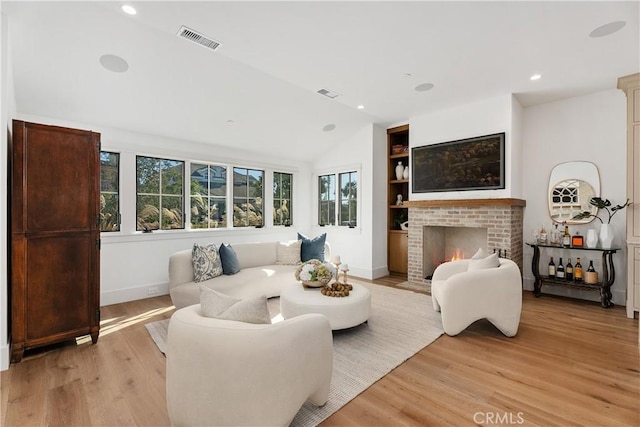 337 Holmwood Dr, Newport Beach, CA 92663 - living room featuring light wood-type flooring, lofted ceiling, built in features, a brick fireplace, and recessed lighting