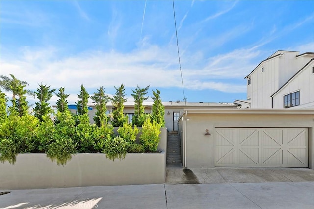 337 Holmwood Dr, Newport Beach, CA 92663 - view of front of property featuring a garage, driveway, and stucco siding