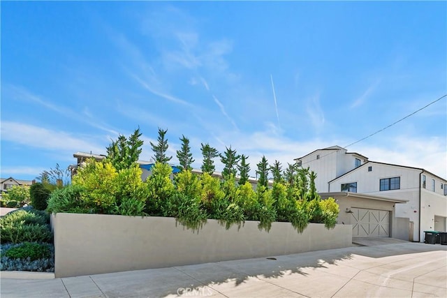 337 Holmwood Dr, Newport Beach, CA 92663 - view of front facade with driveway, a garage, and stucco siding