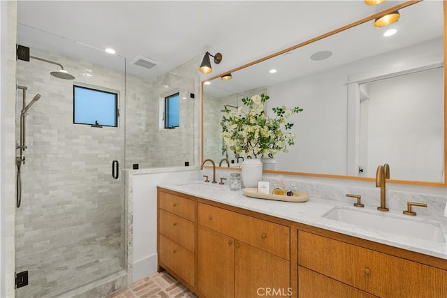 bathroom featuring vanity and an enclosed shower