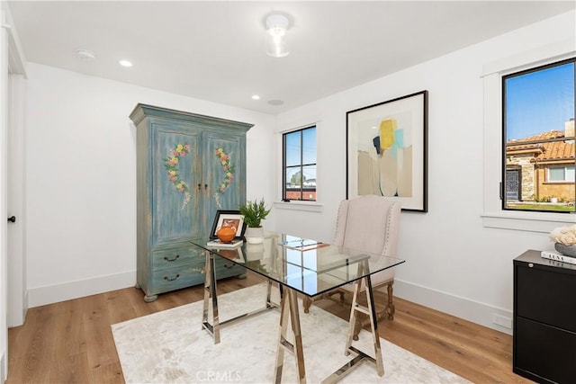 office space with light hardwood / wood-style flooring