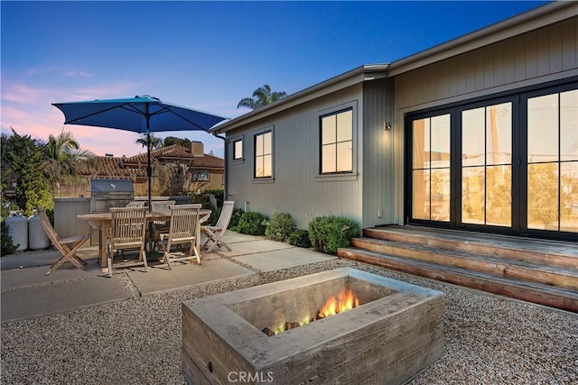337 Holmwood Dr, Newport Beach, CA 92663 - view of patio featuring a fire pit, area for grilling, entry steps, and outdoor dining space