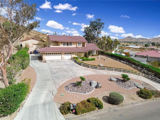 mediterranean / spanish home with a mountain view and a garage