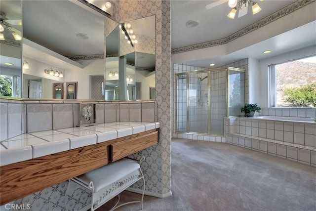 bathroom featuring vanity, plenty of natural light, and independent shower and bath