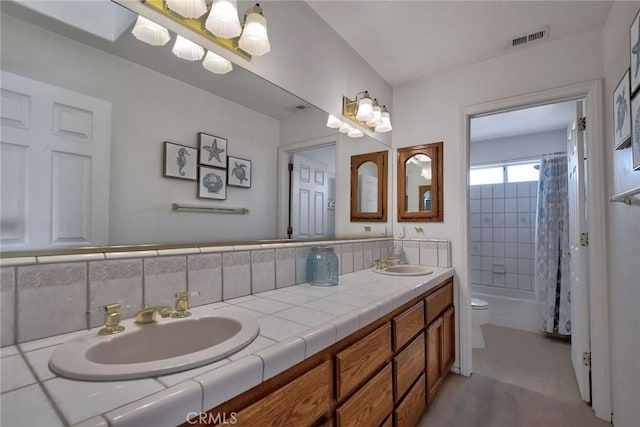 full bathroom with vanity, toilet, shower / tub combo, and tasteful backsplash