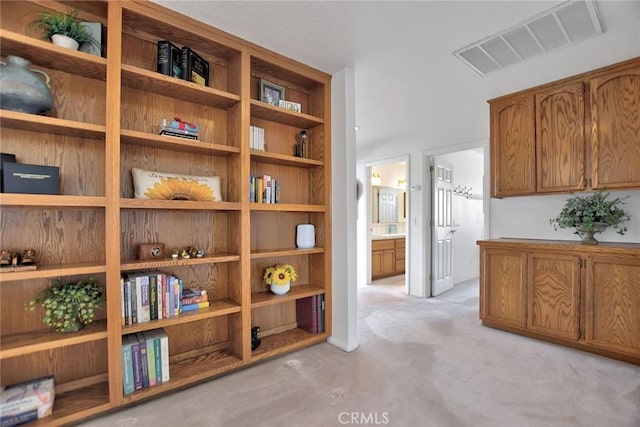 corridor featuring light colored carpet